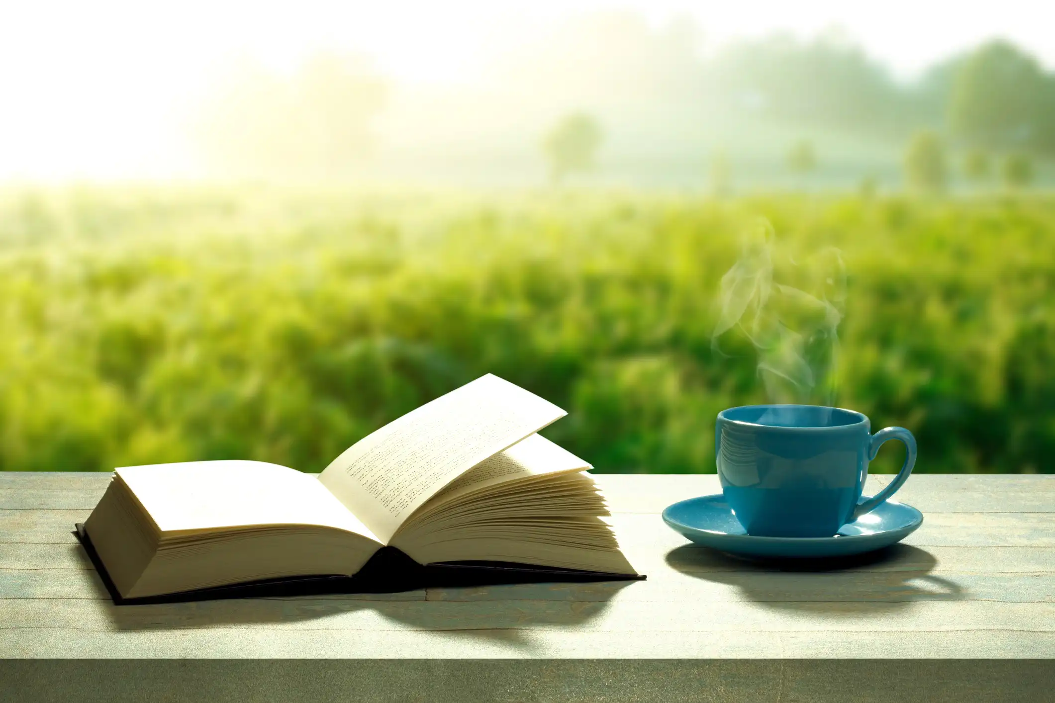 Steaming Coffee & Open Book at Sunrise Steaming Coffee & Open Book at Sunrise