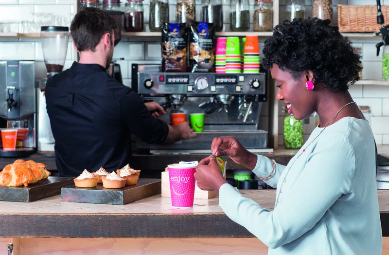 Woman Preparing Tea at Café Counter