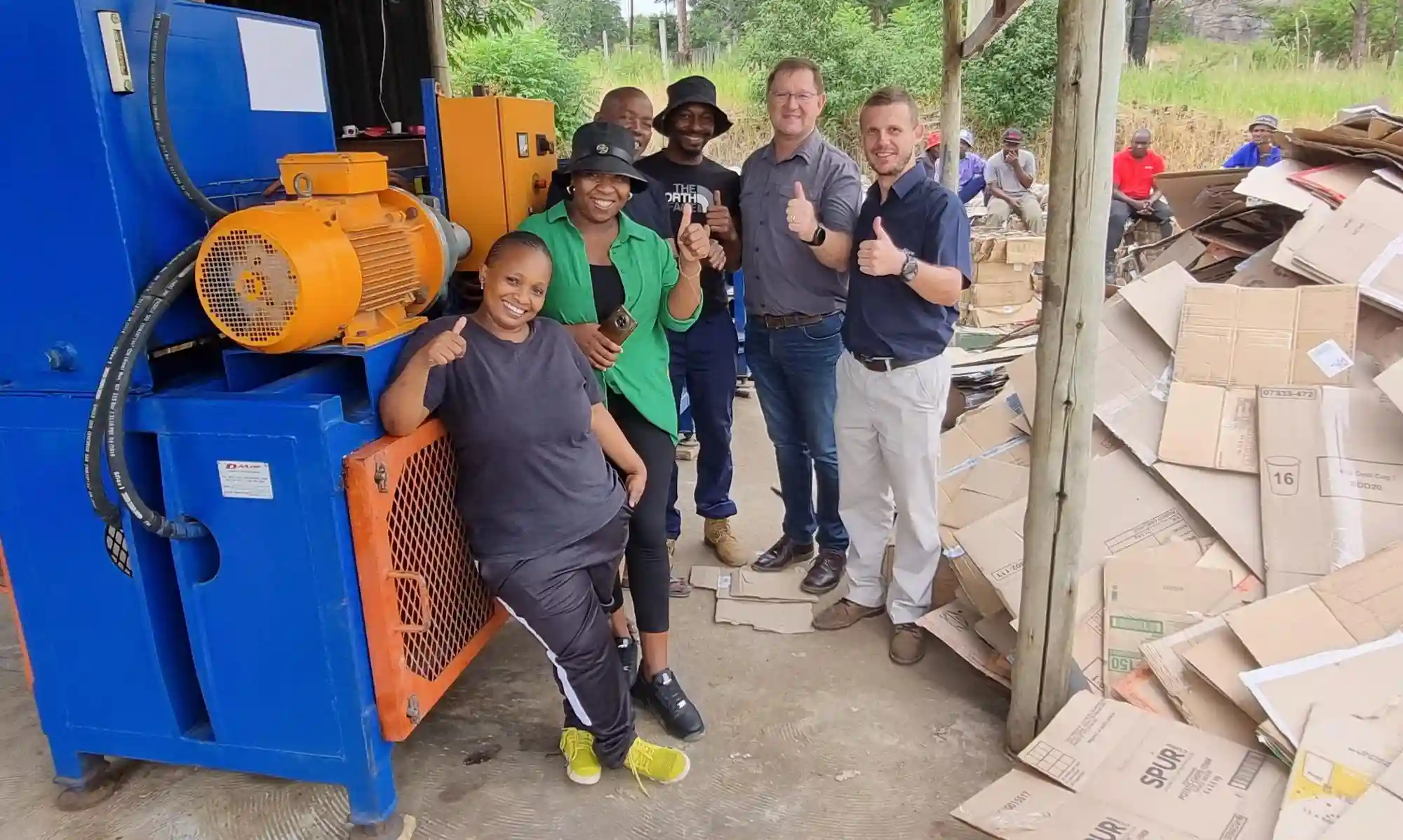 Cardboard Recycling Team Smiling Thumbs Up