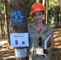 forestry researcher standing by marked tree