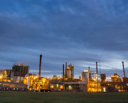 paper mill at dusk with lights