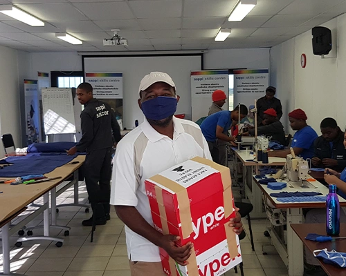 skills centre worker holding supplies