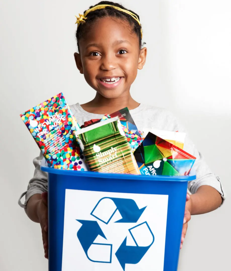 Child Holding Recyclable Beverage Cartons